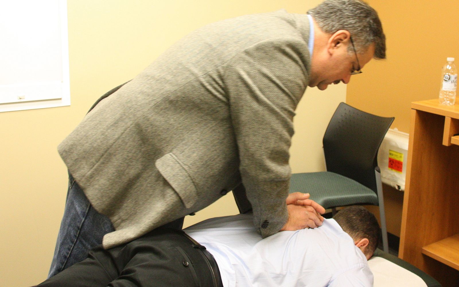 A chiropractor performing a spinal adjustment